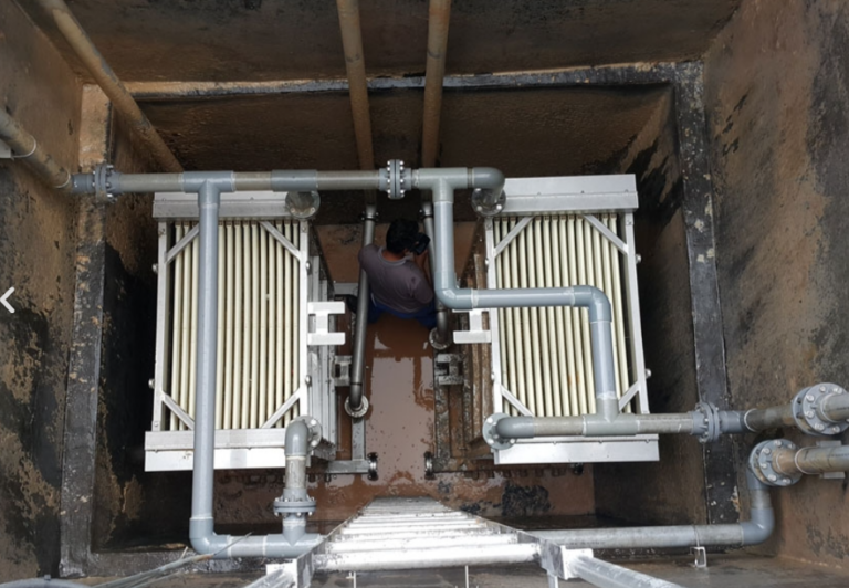 features parallel membrane modules, grey piping, and support structures