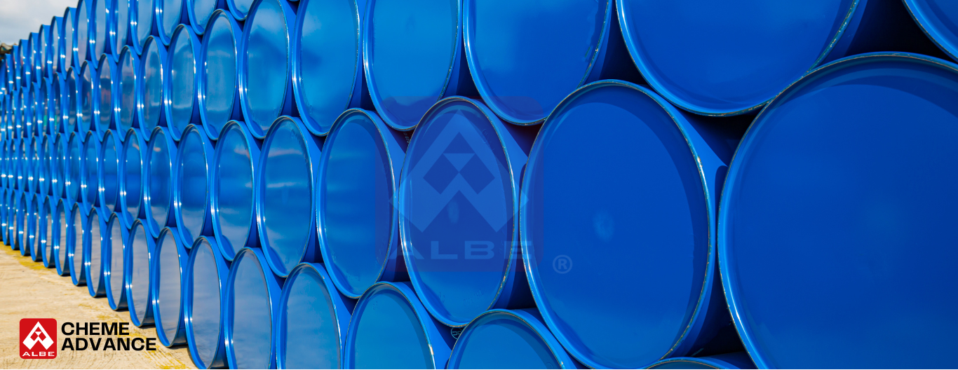 Stacked blue barrels used in coagulation and flocculation in water treatment, arranged neatly at an industrial site.